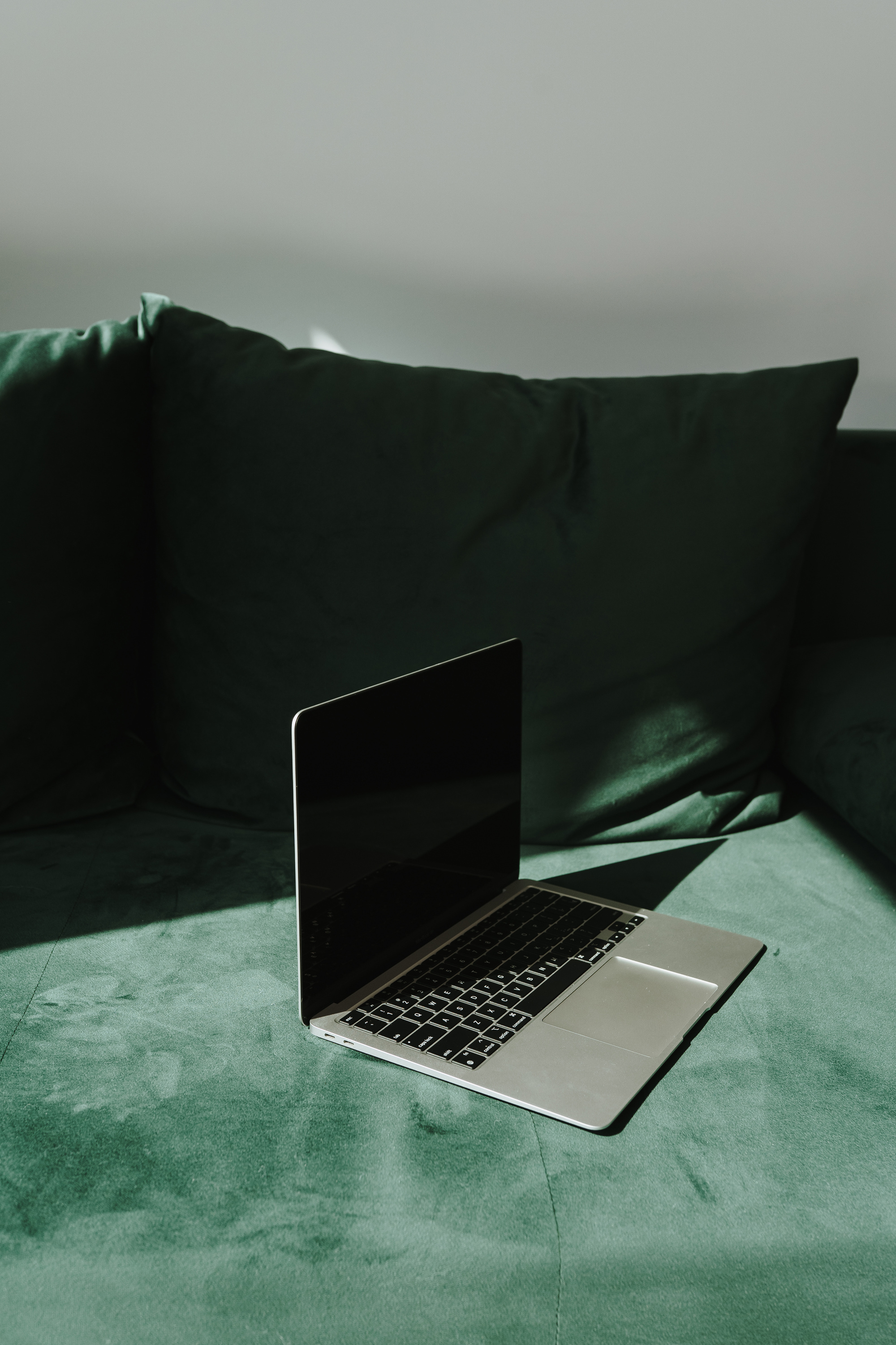 Laptop on Green Sofa